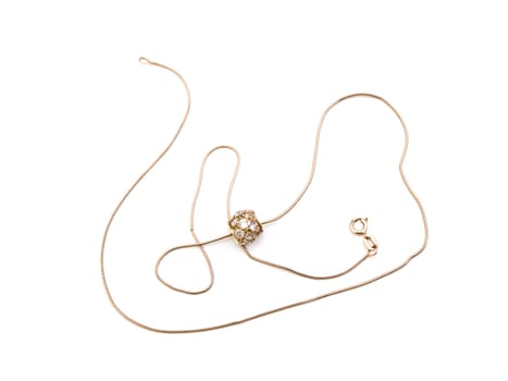 Golden necklace with pendant against the white background