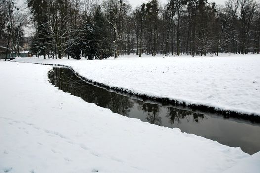brook in snowy karvina park, horizontally framed shot