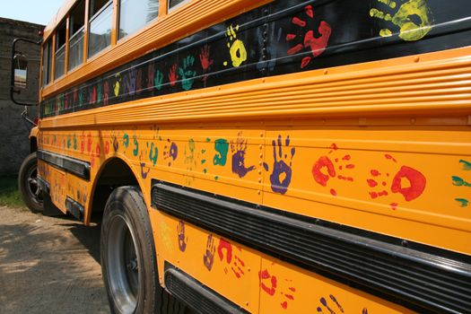 School bus with kids hands painted on the side