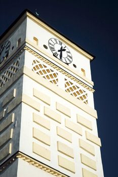 white clock tower at Karvina square with very dark blue sky