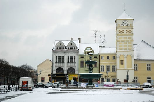 snowy karvina square with tower, horizontally framed shot