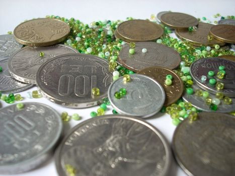A nice texture of coins and green glass beads