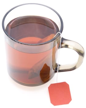 glass teacup with  tea bag on white background