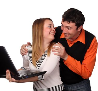 couple having fun with laptop, pretty blonde and handsome young dark haired man
