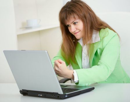 The young woman threatens with a fist to the virtual interlocutor