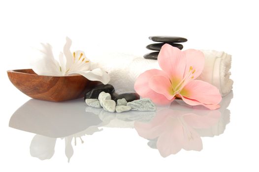 wellness zen and spa still life with flower towel and pebbles isolated on white