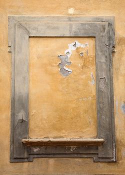 Typical window in Tuscany, bricked-up and with flaking paint.