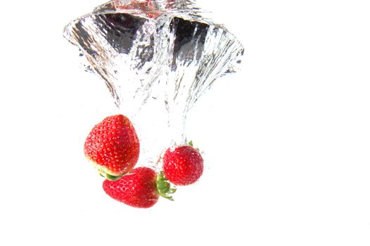 strawberry splash in warter showing healthy lifestyle