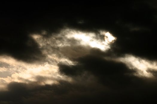 sun lurking behind story clouds