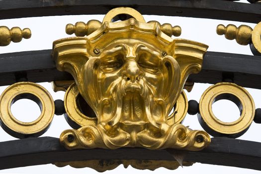 A gold mask from a surround outside Buckingham Palace, London, England