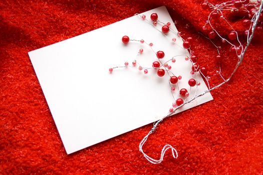 White blank note with red beads decoration on red background