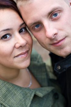 Closeup of a young happy couple together.  Shallow depth of field.