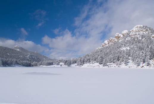 Copeland Lake in winter with a fast moving sky.