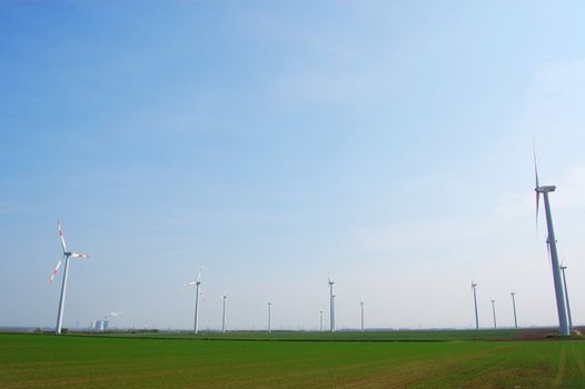 wind turbine under blue sky for alternative energy