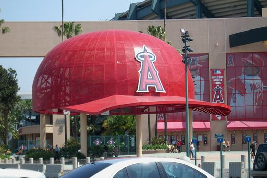 Angels fans pass under massive baseball caps on their way to the gates for a day baseball game in California.