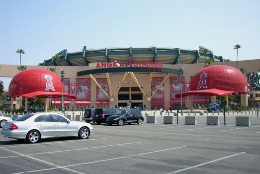 Angels fans pass under massive baseball caps on their way to the gates for a day baseball game in California.