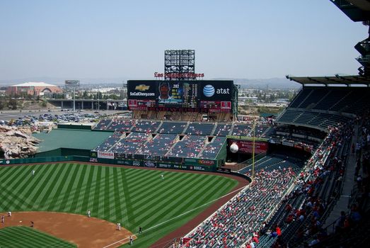 Angels baseball team in Anaheim during a day game, with California hills in the distance.