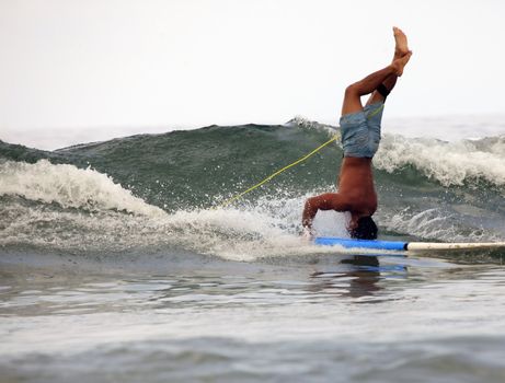 Young men - the surfer in ocean. Bali. Indonesia