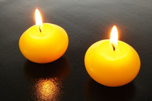 yellow candles showing spa or welllness concept