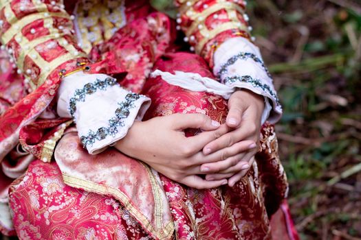 girl hands and medieval red dress
