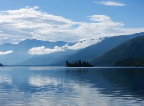 Island on lake in mountains
