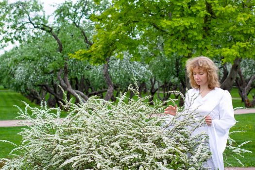 The blonde girl in white dress and white flowers
