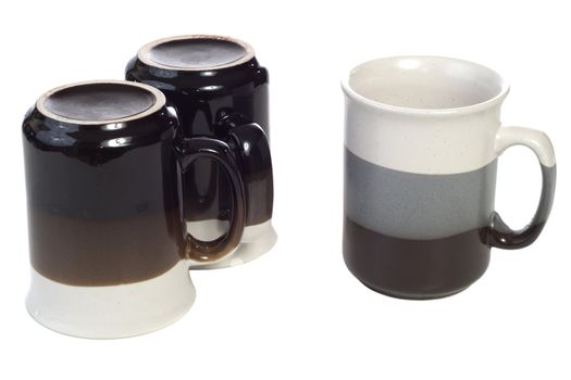 Three coffee cups with nothing in them, isolated against a white background
