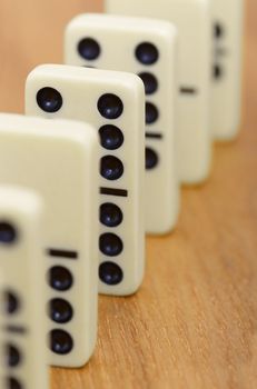 Dominoes bones on a wooden surface abreast