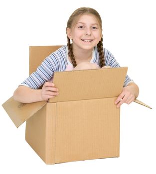The amusing little girl sits in a cardboard box isolated on a white background
