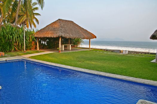 Luxury tropical pool overlooking ocean and cabana