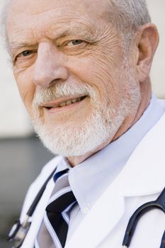 Portrait of an Old Male Doctor Smiling Directly To Camera