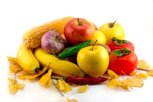 Autumn still-life with vegetables, fruit and yellow leaves
