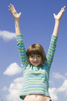 Portrait of a smiling young girl with open hand.