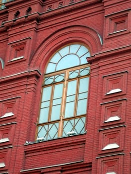 Very beautiful window in a red wall at building on Red Square in Moscow