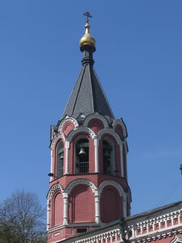 A red bell tower at the church, it situates near the center of Moscow