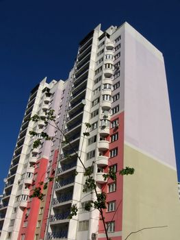 High strong colored house on a background of blue sky