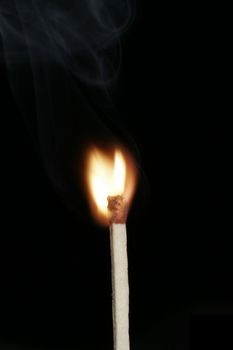 Burning Flame On A Single Matchstick On A Black Background