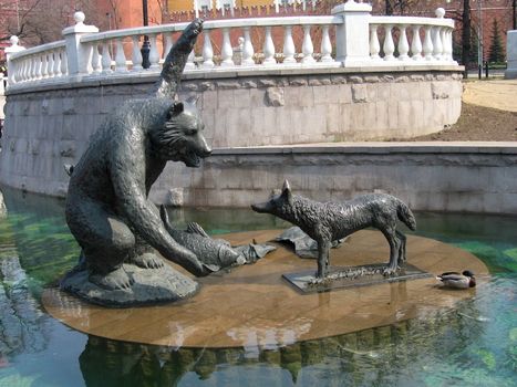 Moscow statue of a bear and a wolf, which divide fish