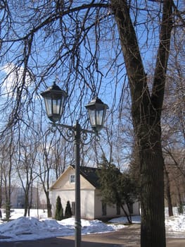 Old flashlight in Moscow park at winter day