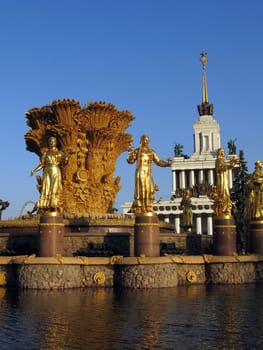 Moscow fountain friendship of nations and house of soviet on a background of blue sky