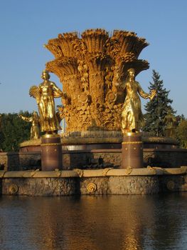 Very beautiful gold Moscow fountain on a background of blue sky
