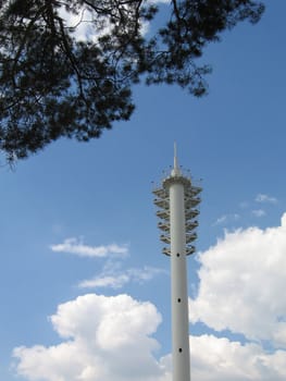 Very beautiful single flashlight on a background of blue sky with clouds