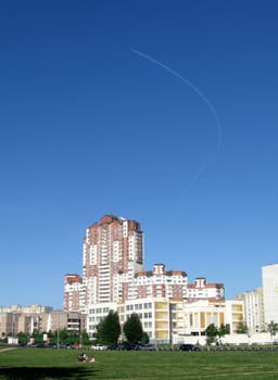 Beautiful Moscow urban landscape on a background of blue sky with airplane trace