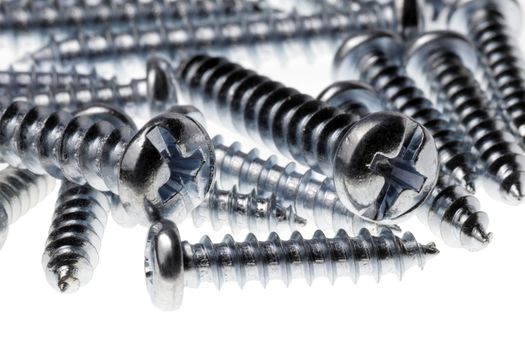 Macro Close-Up Of Spiral Metal Screws On A White Background