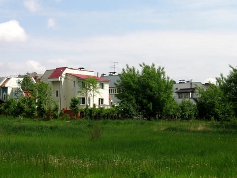 Beautiful public white cottages at sunny day with a lawn in front