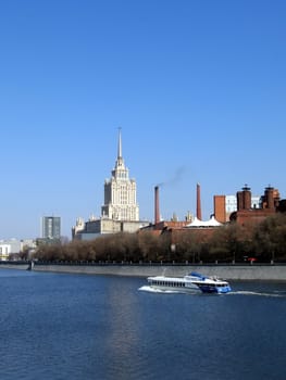 Bank of Moscow river with steamboat on a background of blue sky