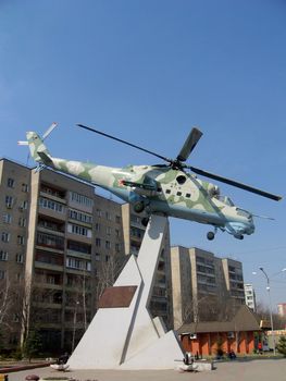 Helicopter at the pedestal on a background of blue sky