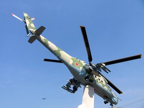 Helicopter at the pedestal on a background of blue sky