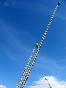 Very high metal fire ladders on a background of blue sky