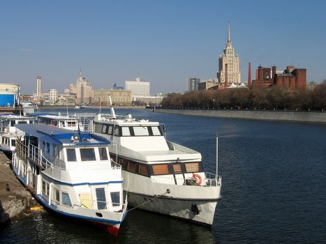 Two white steamboats at Moscow river on a background of blue sky